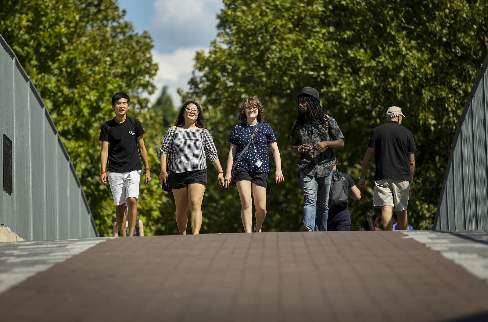 students walking over the 38th street bridge