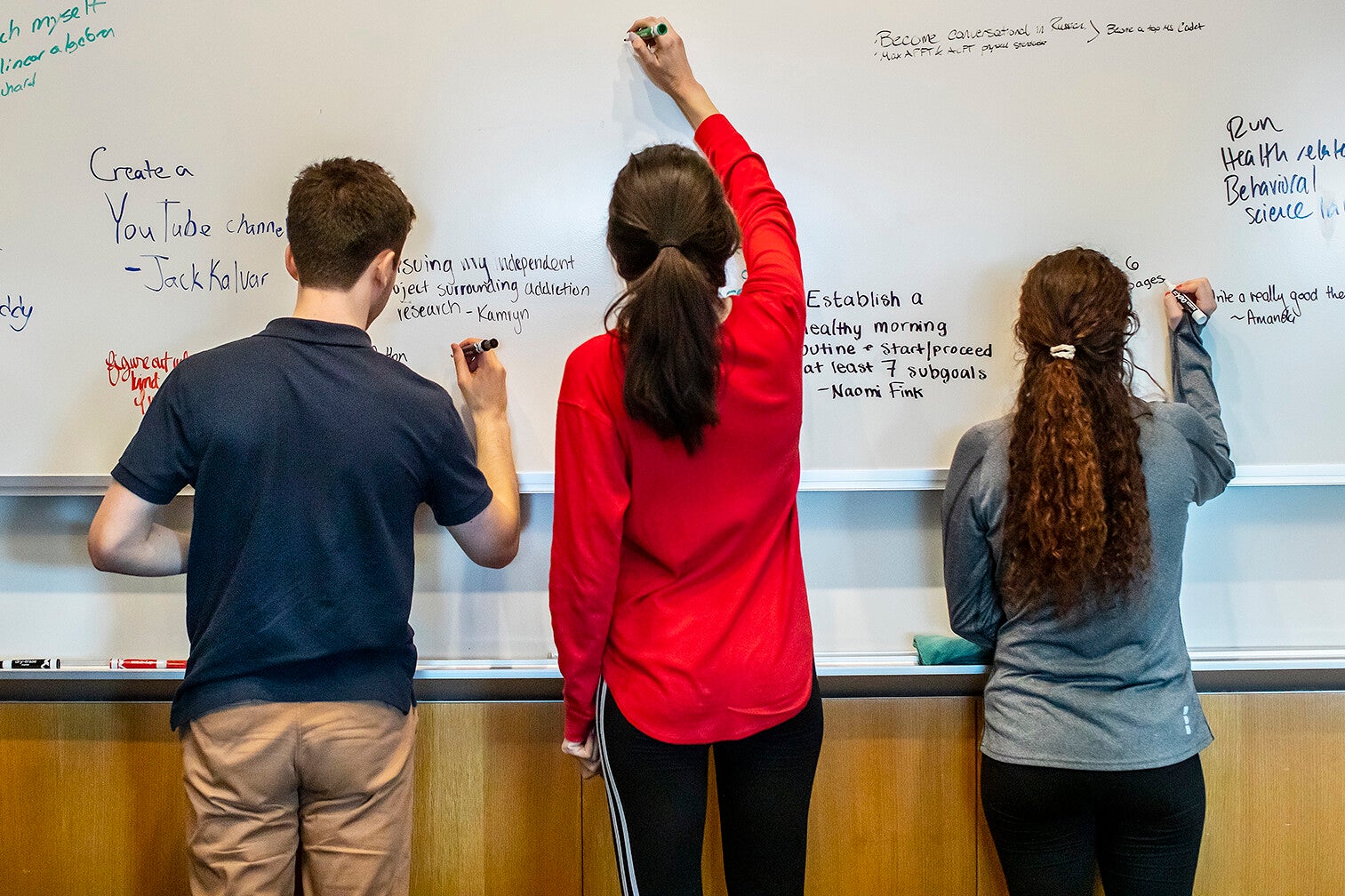 undergrads at a white board