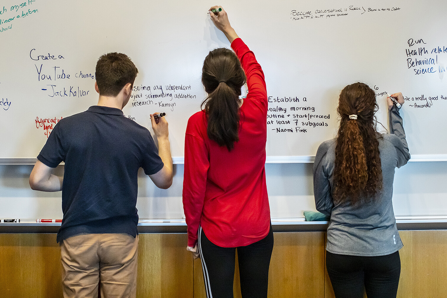 undergrads at a white board