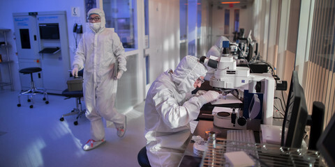 Researchers in protective suits