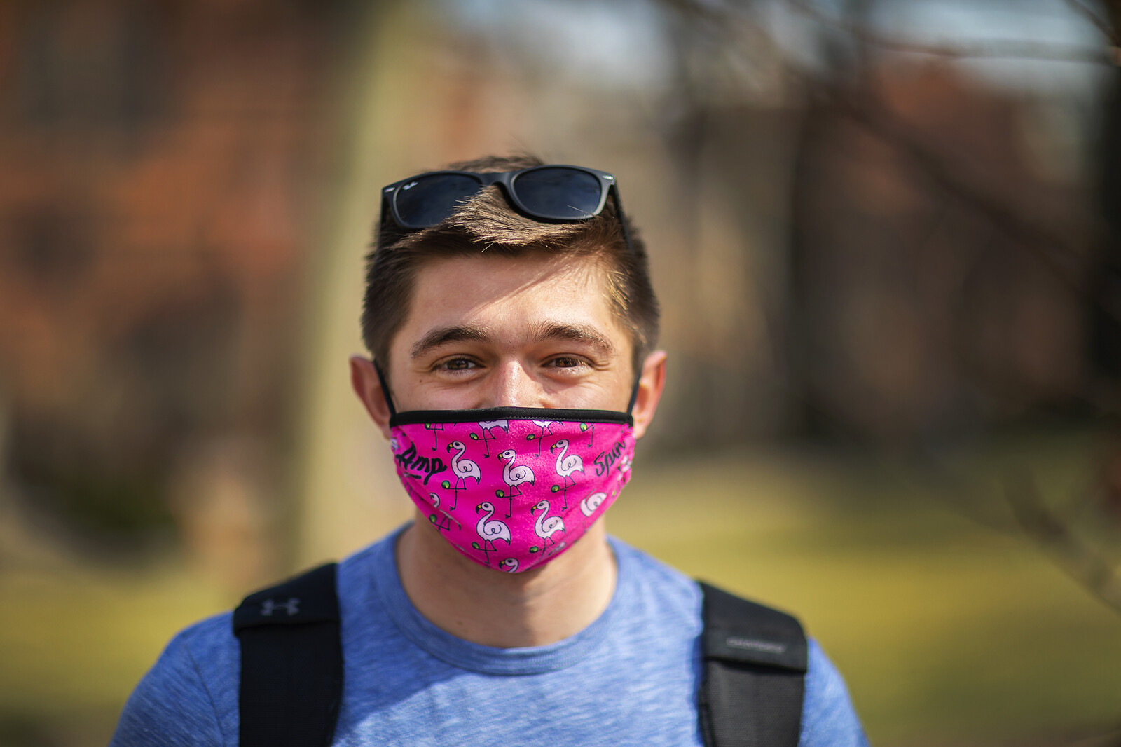 student wearing a pink mask with flamingos