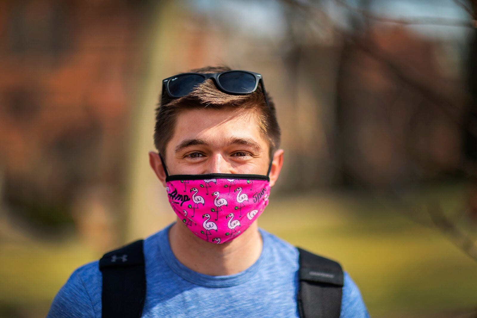 student wearing a pink mask with flamingos