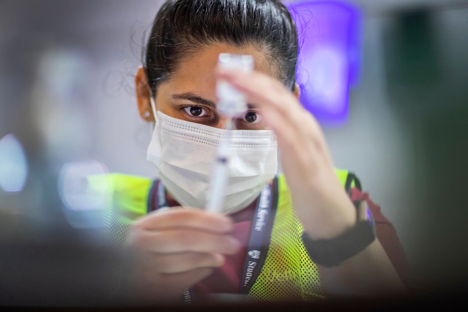 worker at penn vaccine clinic drawing syringe