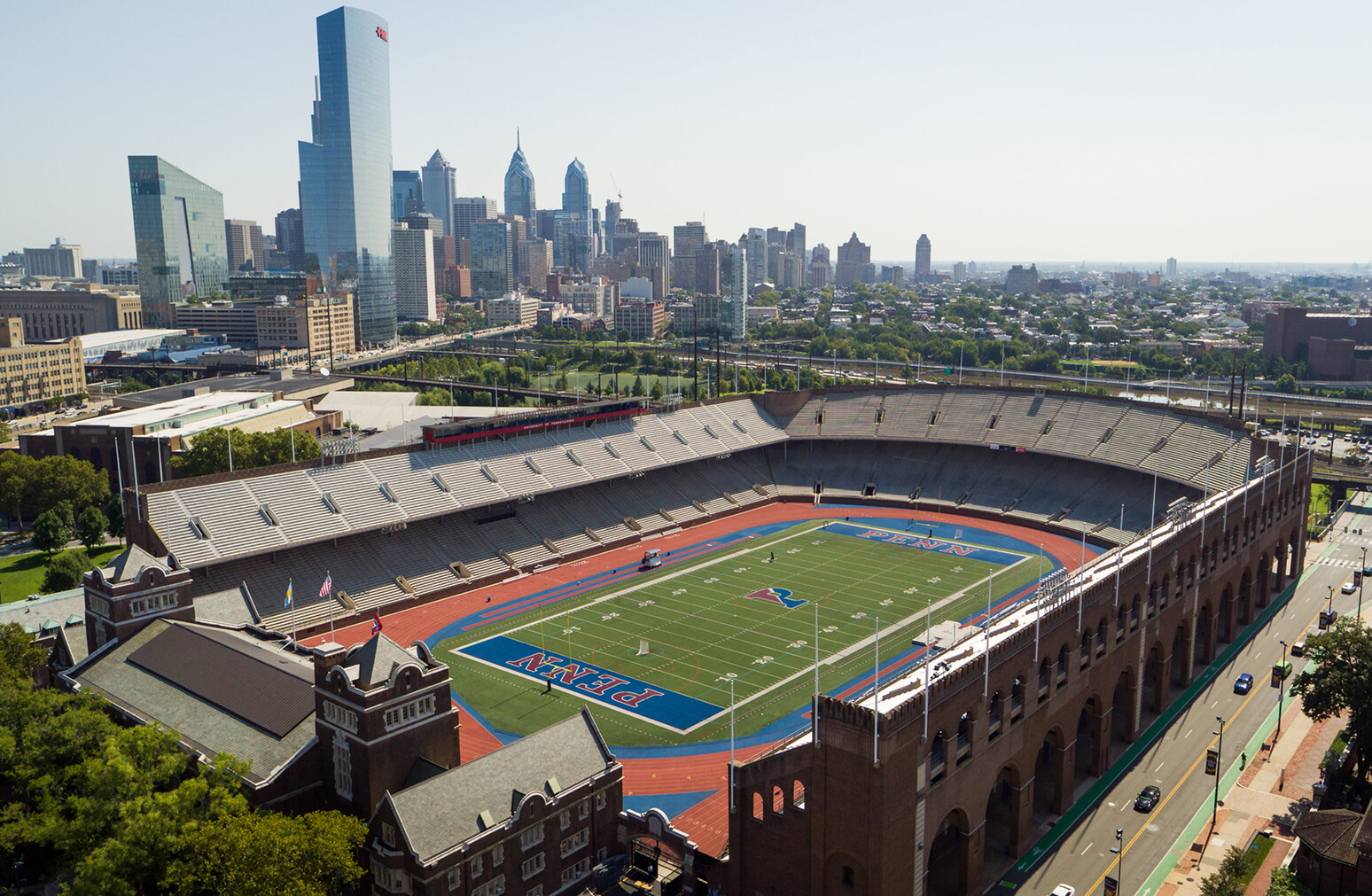 aerial of franklin field with philly skyline in background