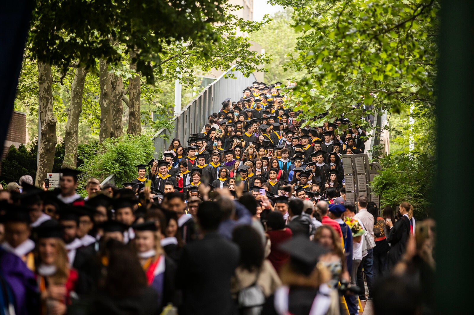 graduates processing down locust walk