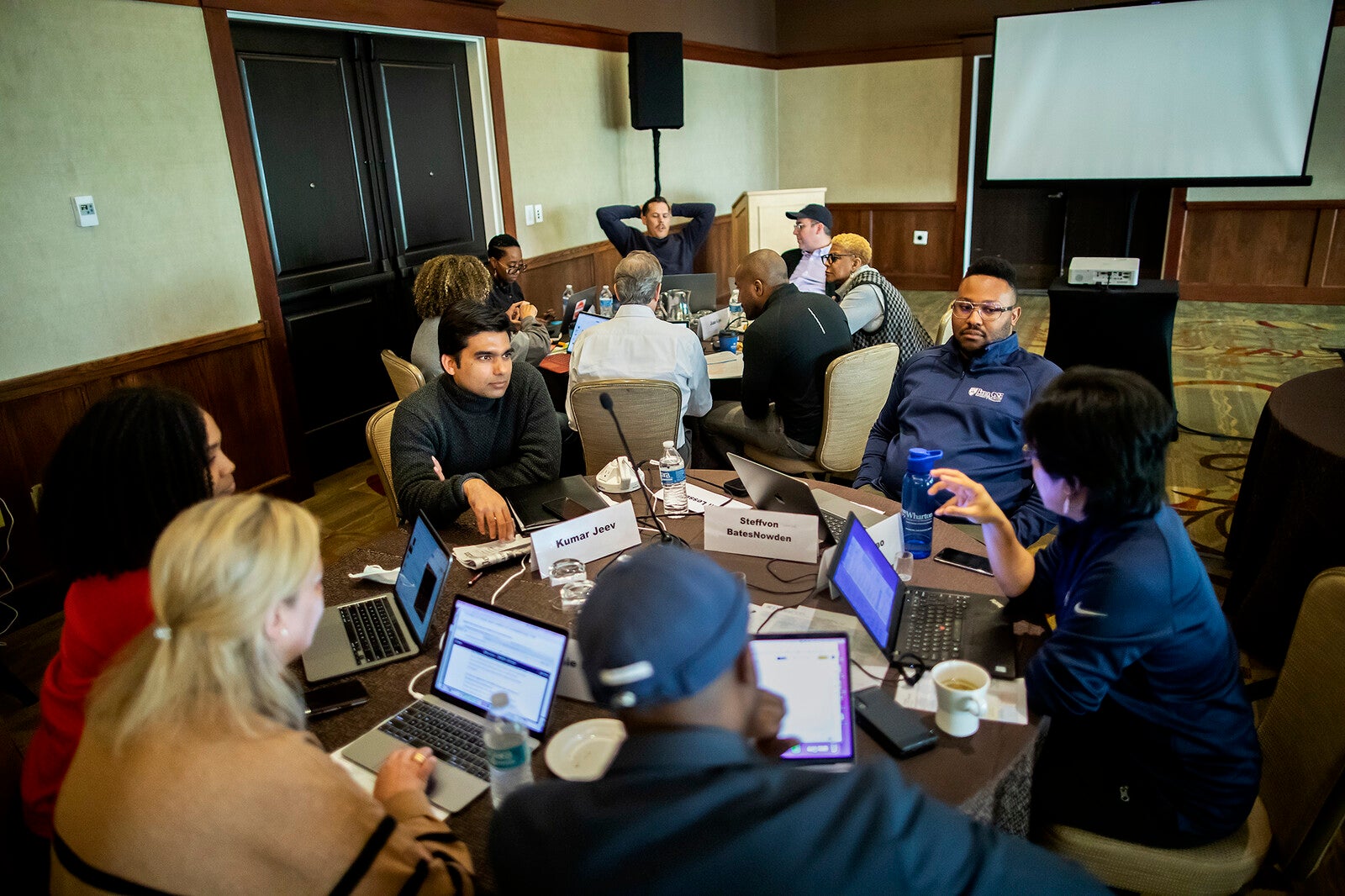 students gather around a table for the clo program