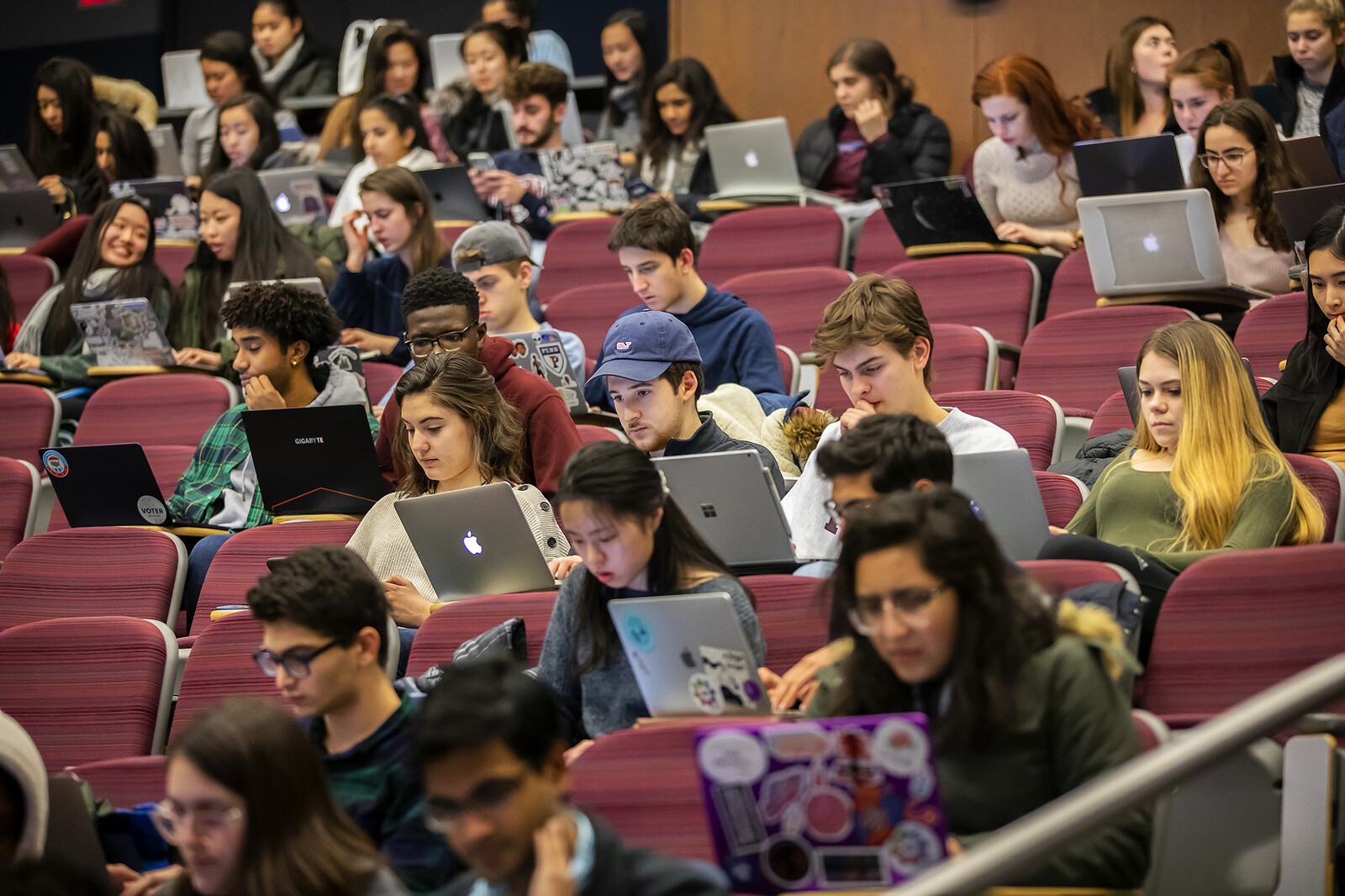 students on laptops in lecture hall