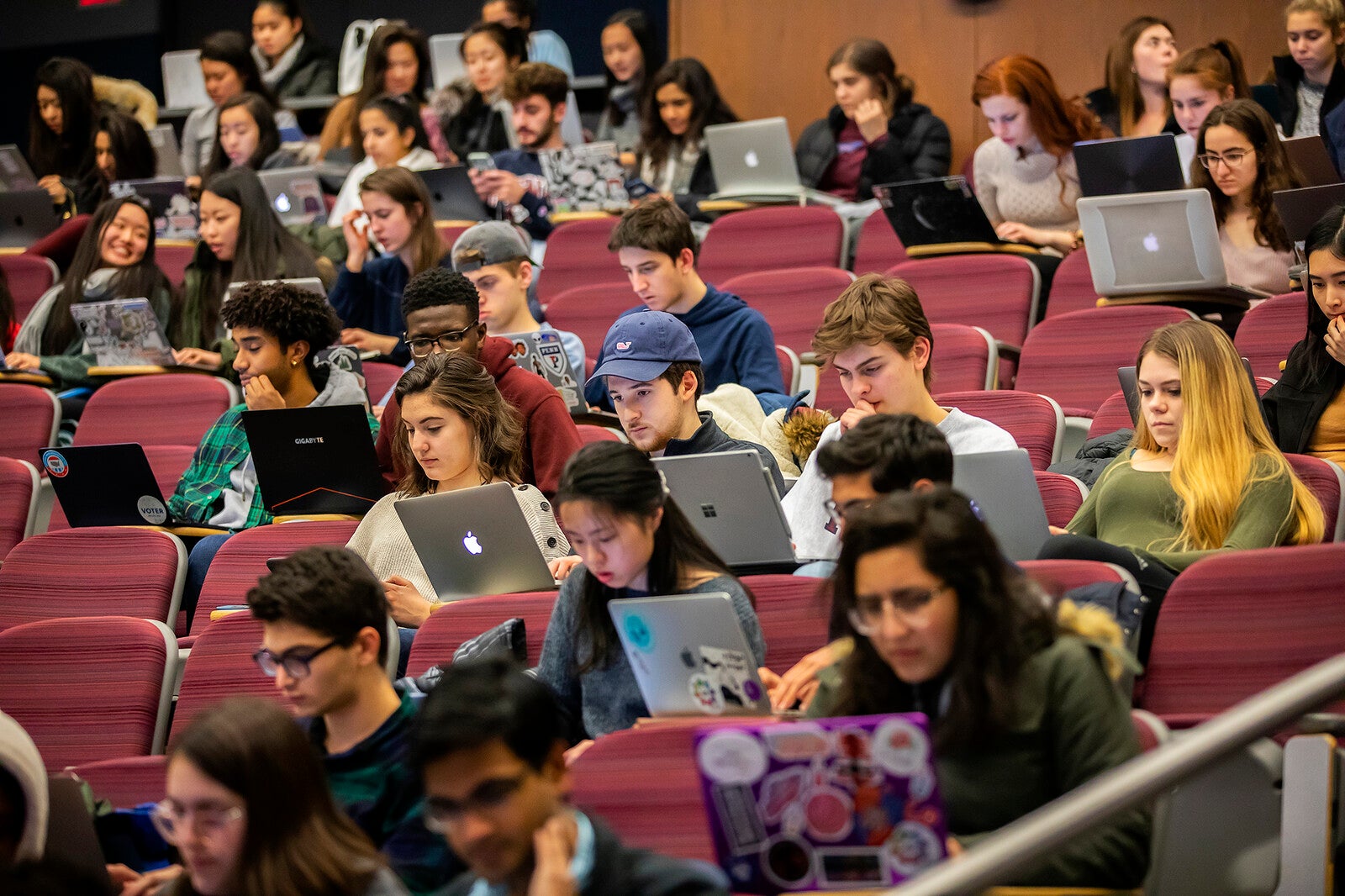 students on laptops in lecture hall