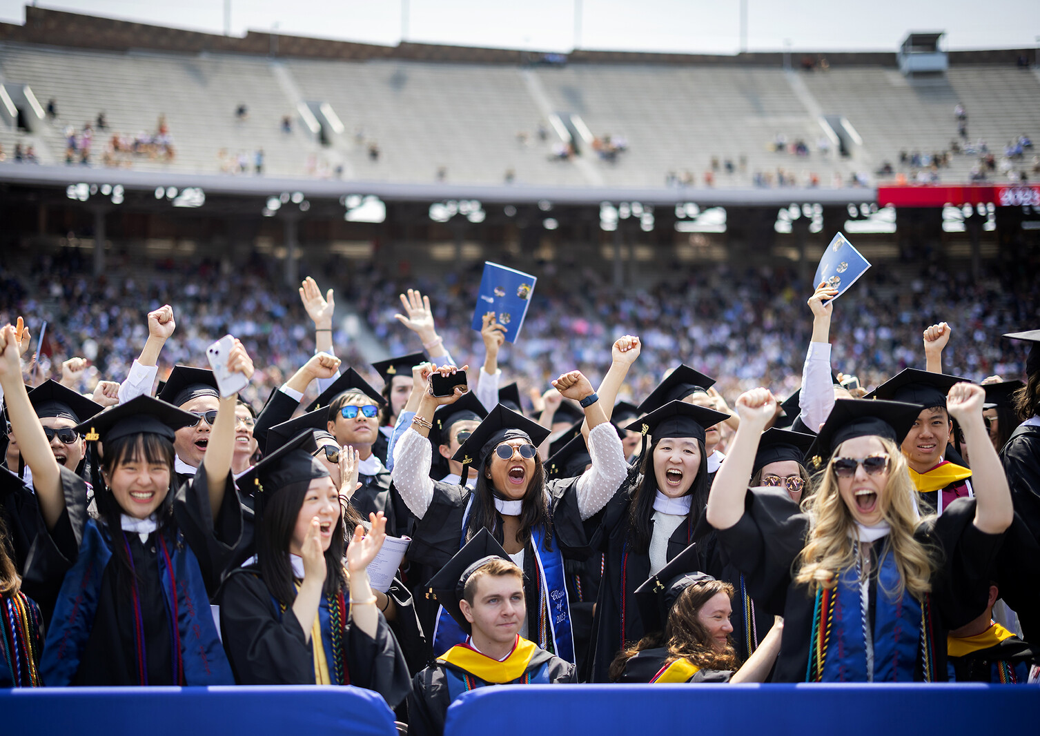 graduates cheering during commencement