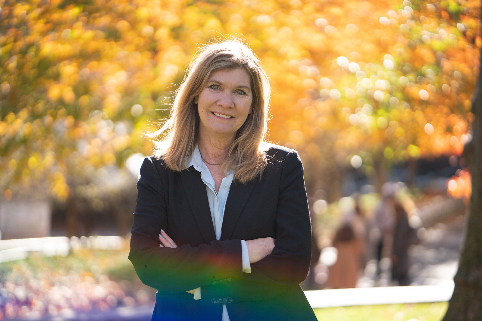 sarah weiser outside in front of fall foliage