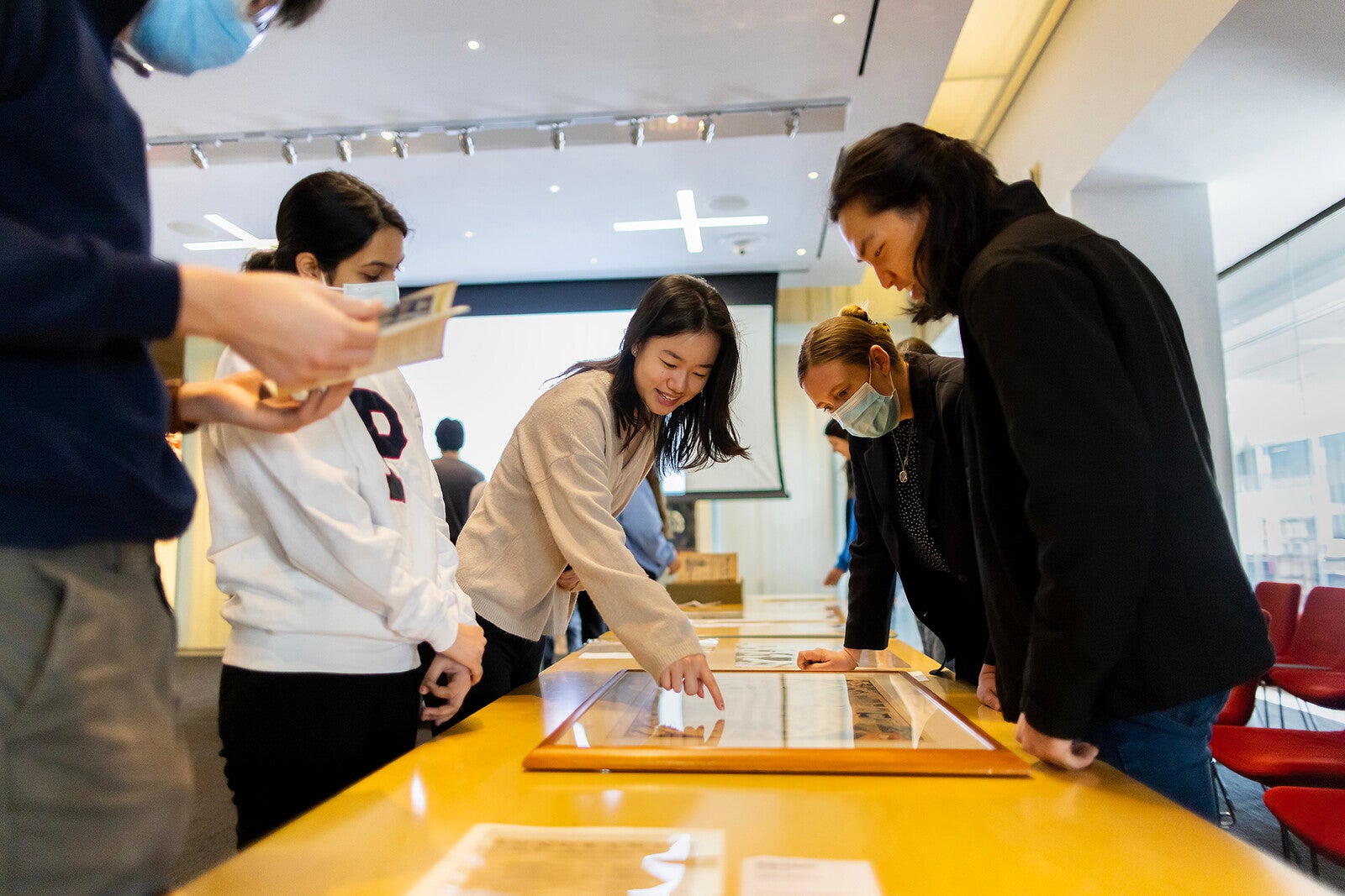 students looking at books at the library kislak center