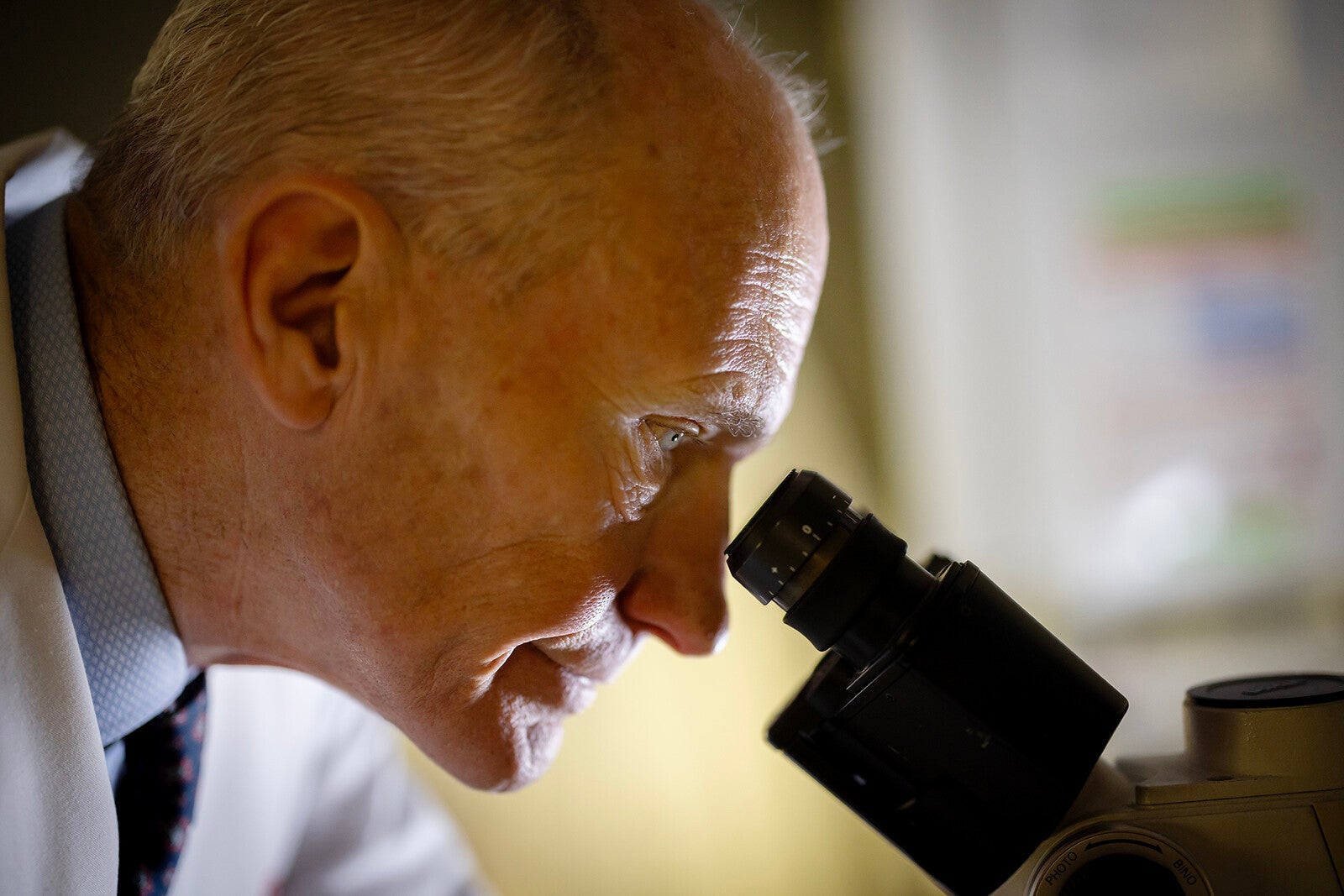 carl june looks through a microscope