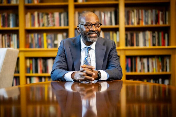 john jackson in front of bookcase