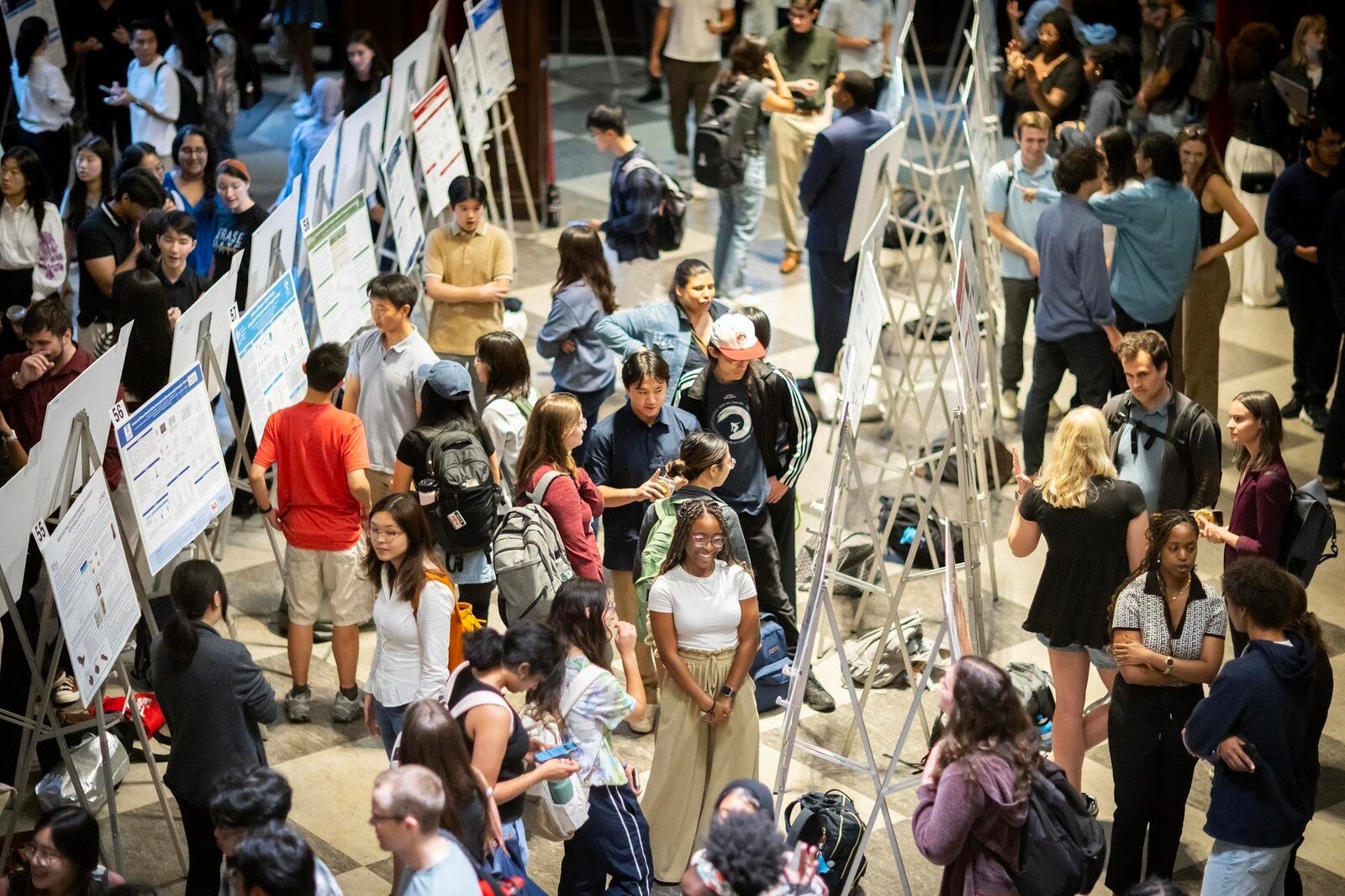 students attending a poster session in houston hall