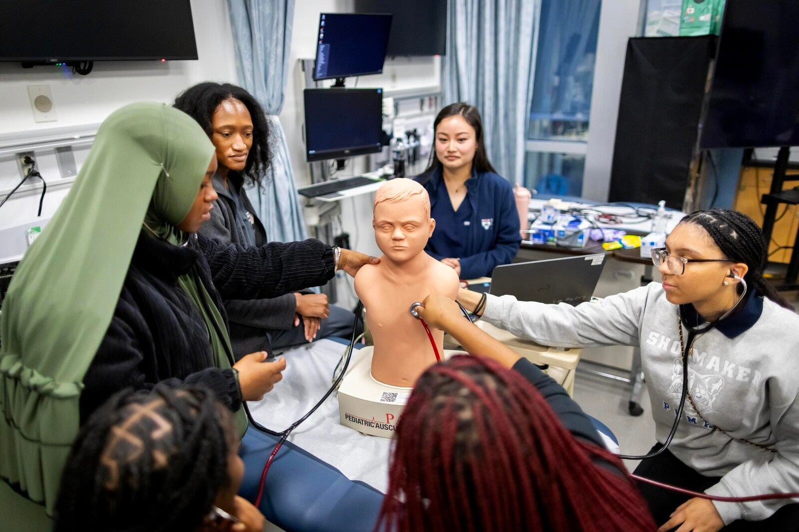students interacting with nursing simulation