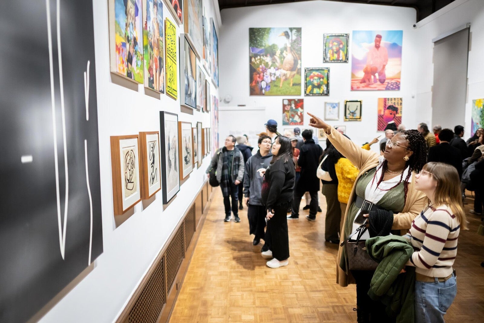 attendees viewing artwork in arthur ross gallery