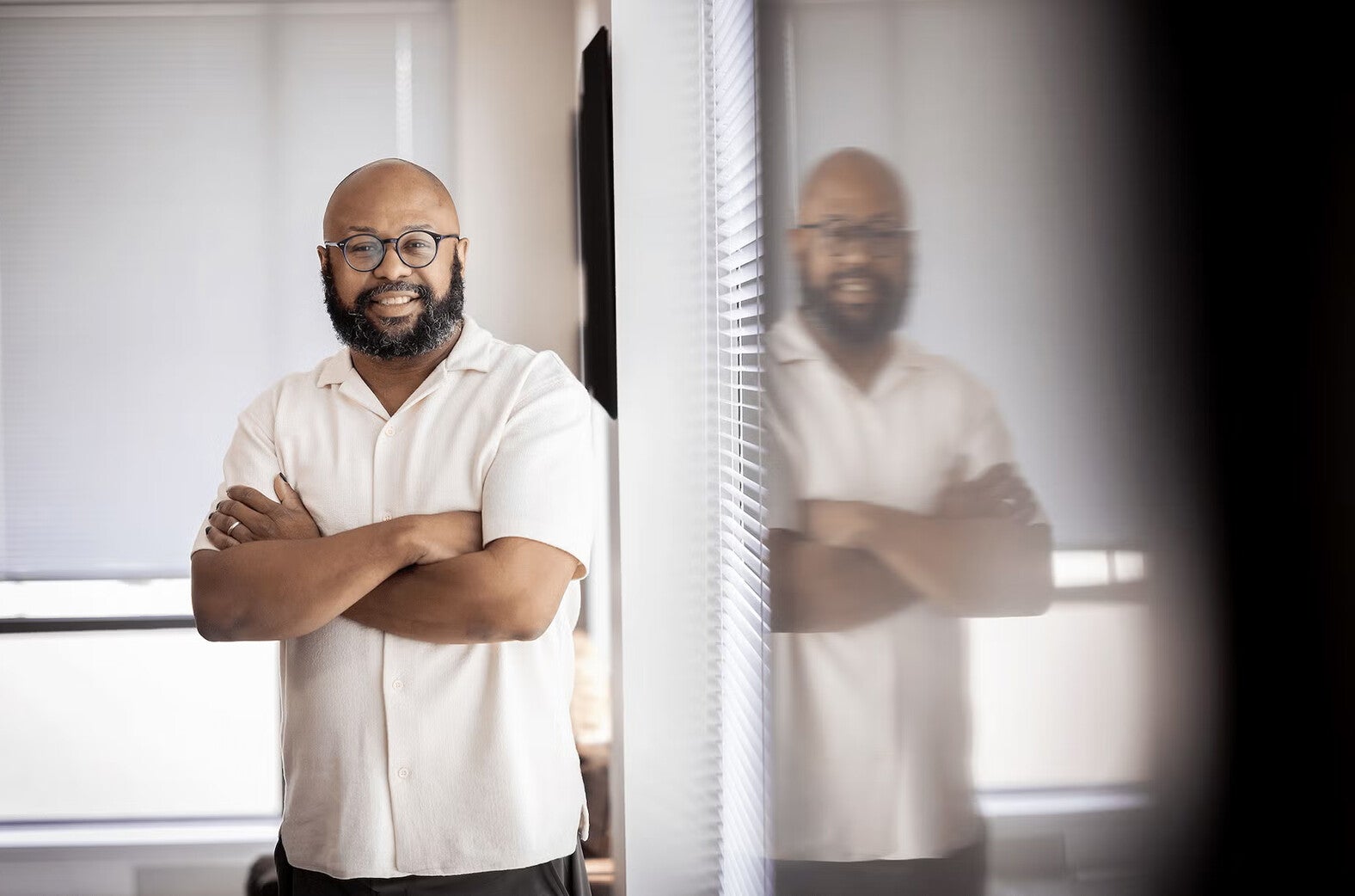 desmond patton standing with arms crossed