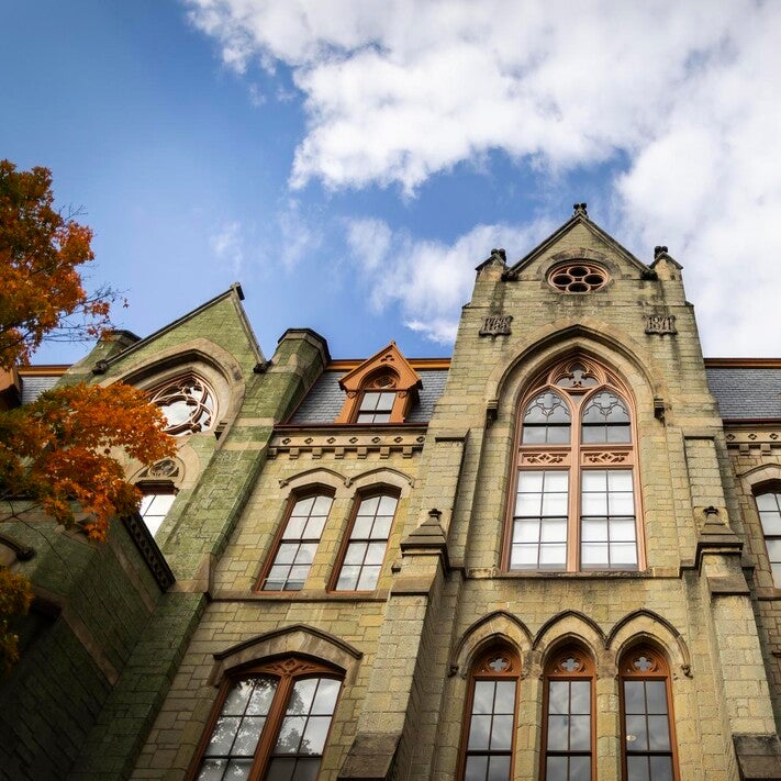 college hall with tree and clouds