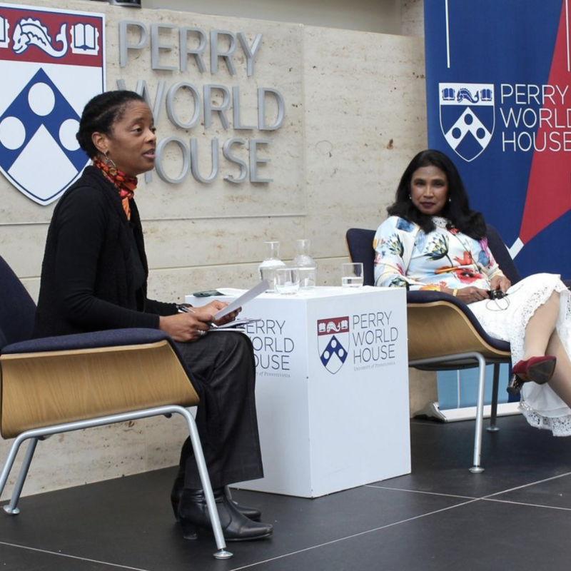 Two female moderators addressing audience at Perry World House