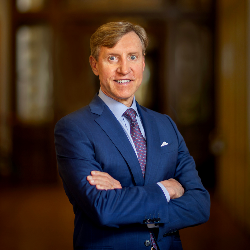 J. Larry Jameson, President of the University of Pennsylvania posing for a photo with his arms folded and smiling.