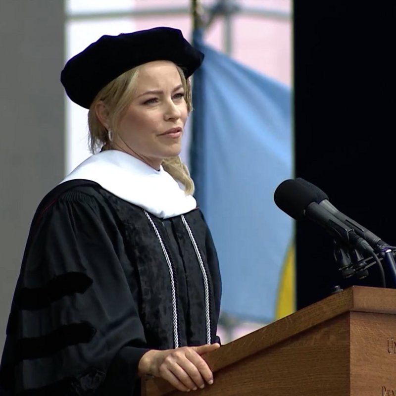 Penn commencement speaker Elizabeth Banks standing at a podium while delivering her speech.