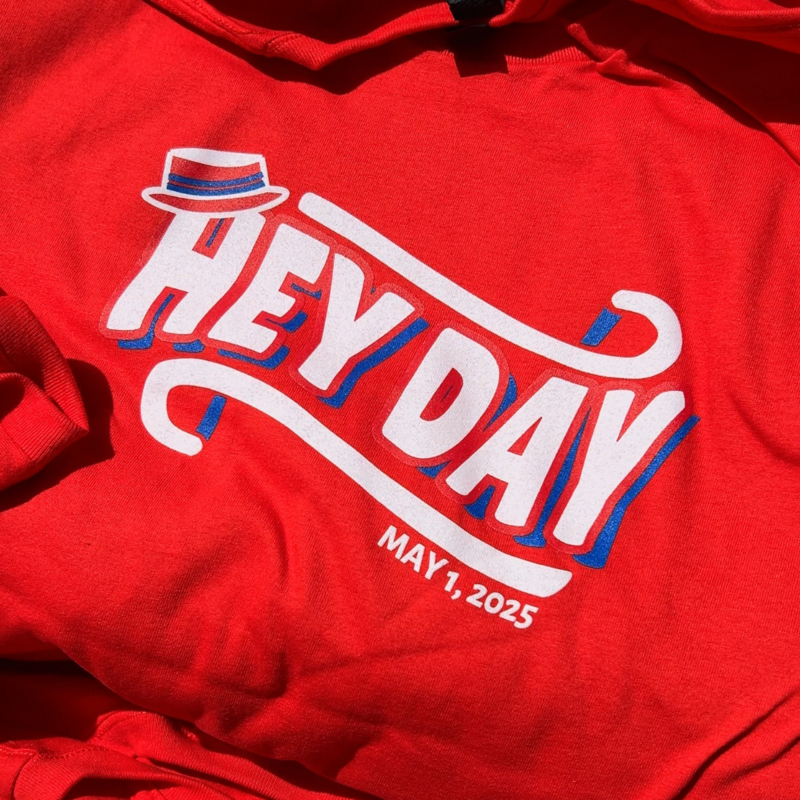 Red shirt that reads "Hey Day, May 1, 2025"