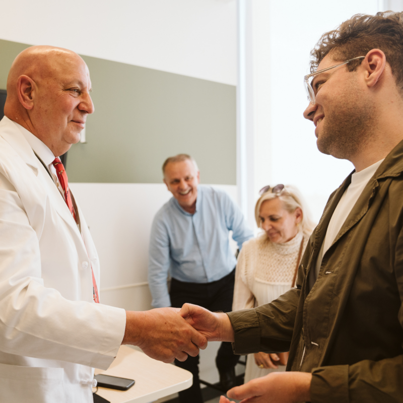 Scott Levin, director of the Penn Hand Transplant Program, greets Luka Krizanac at a reception in June 2025.