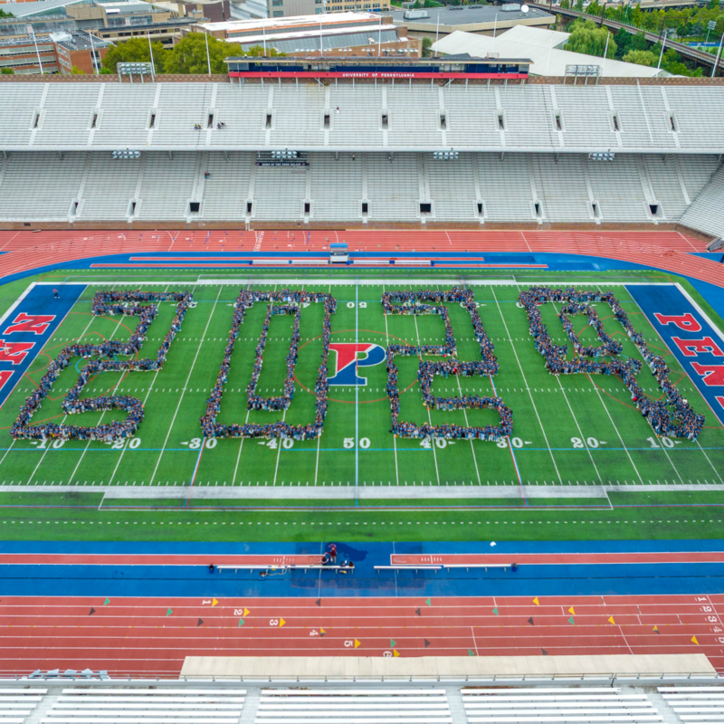The Penn class of 2029 standing on Franklin Field arranged in the numbers "2029".
